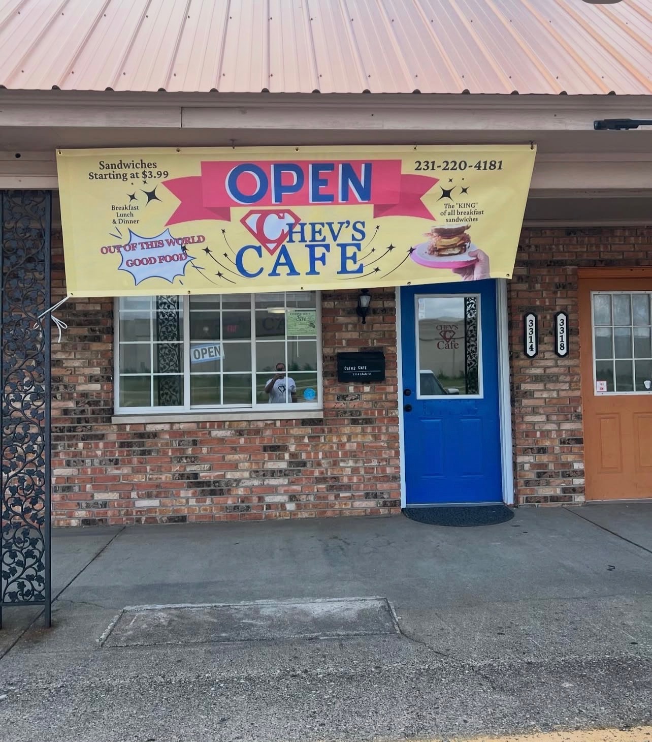 The welcoming storefront of Chev's Cafe on Glade Street in Muskegon